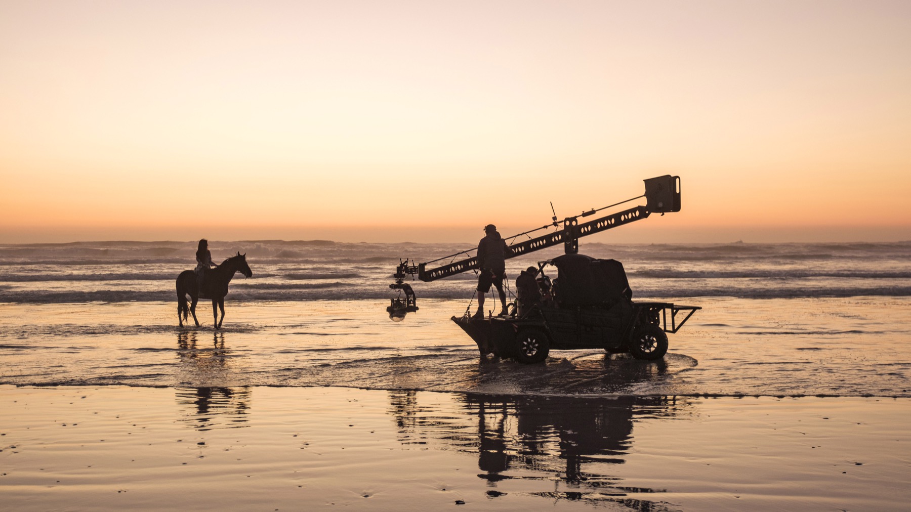 Mackenzie Foy and Beauty filming on the beach at sunset